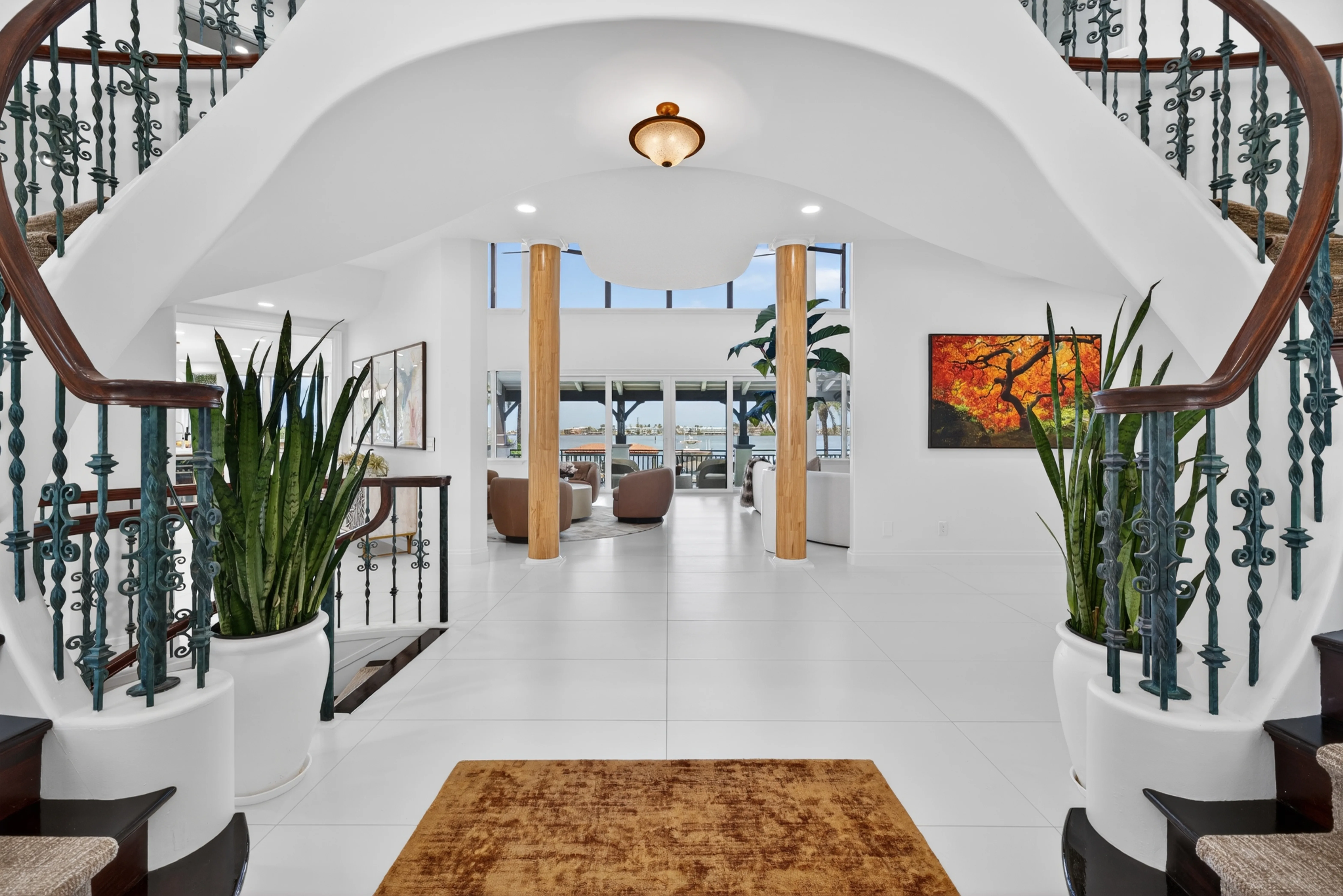 Foyer at dusk — arched columns and sunset water view