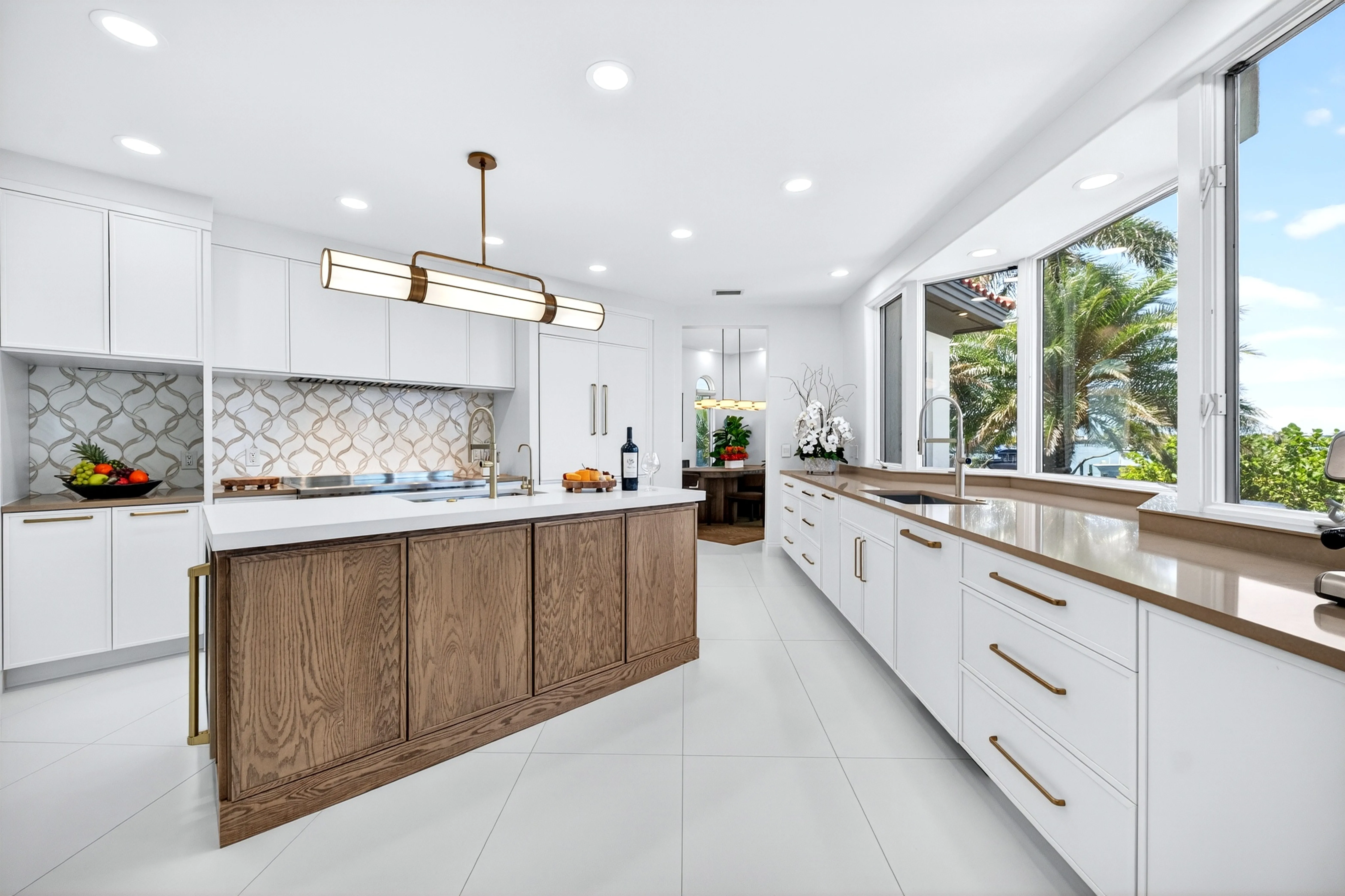 Kitchen island in warm oak with quartz counters