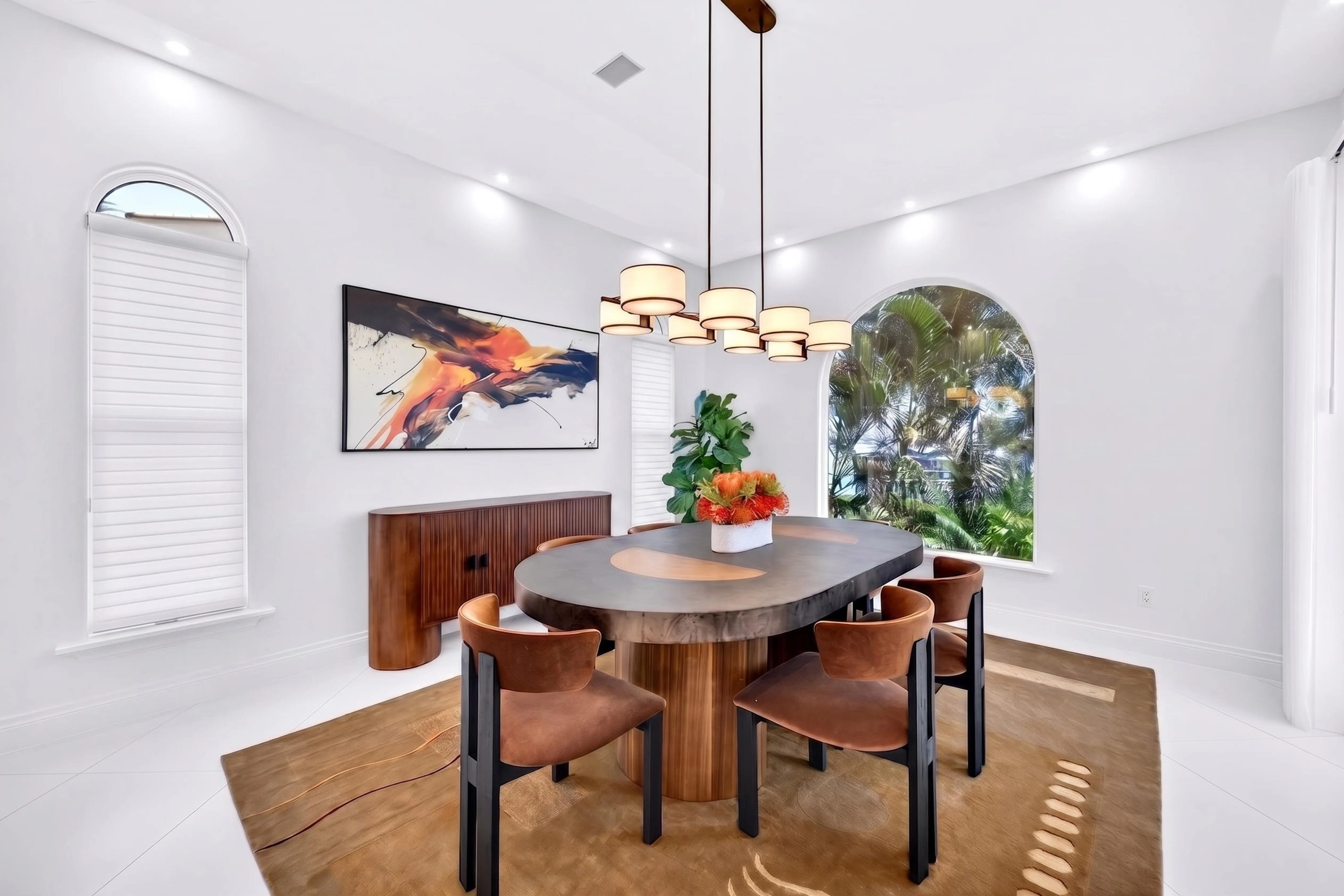 Formal dining room with chandelier and curated artwork