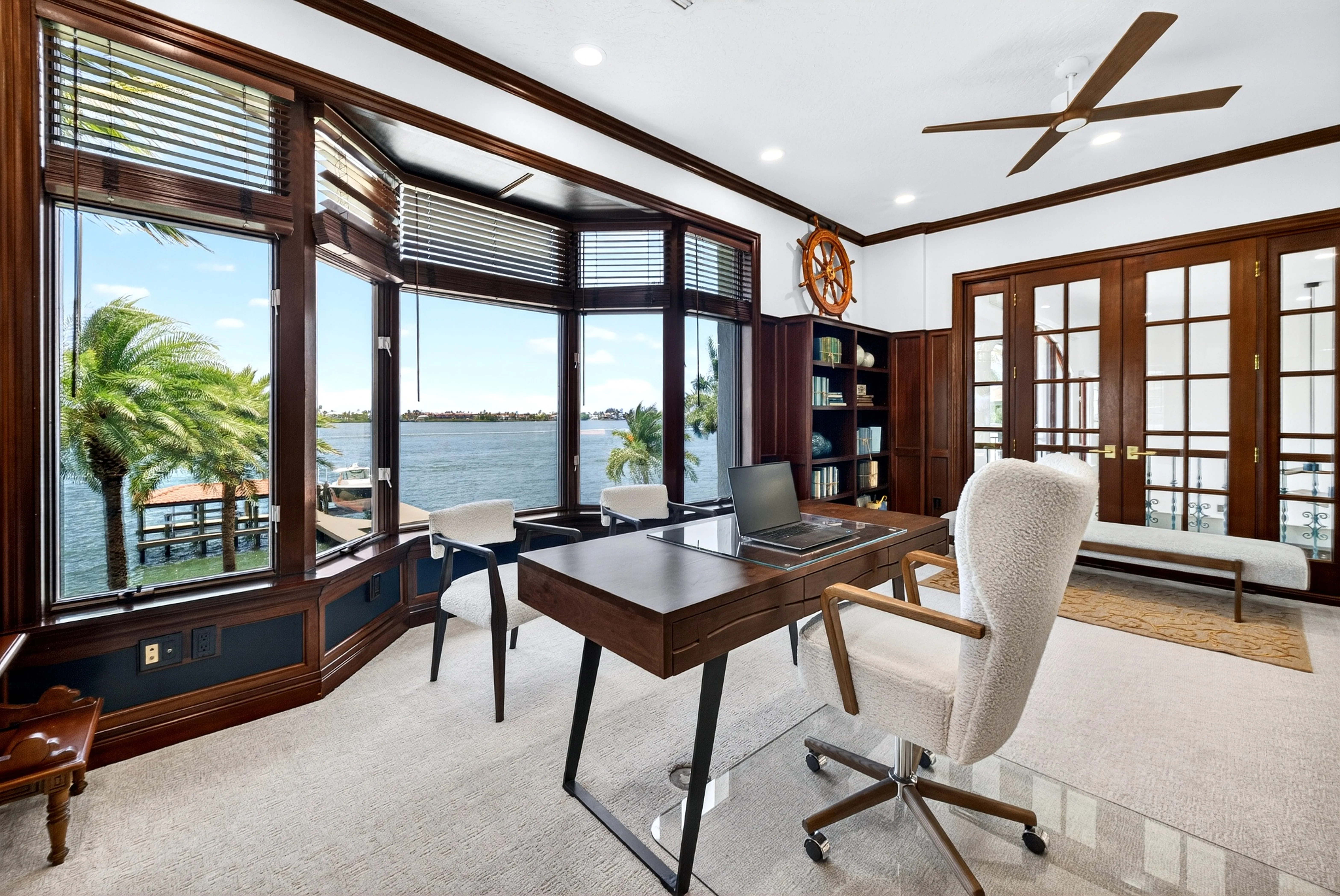 Office desk facing the water through the bay window