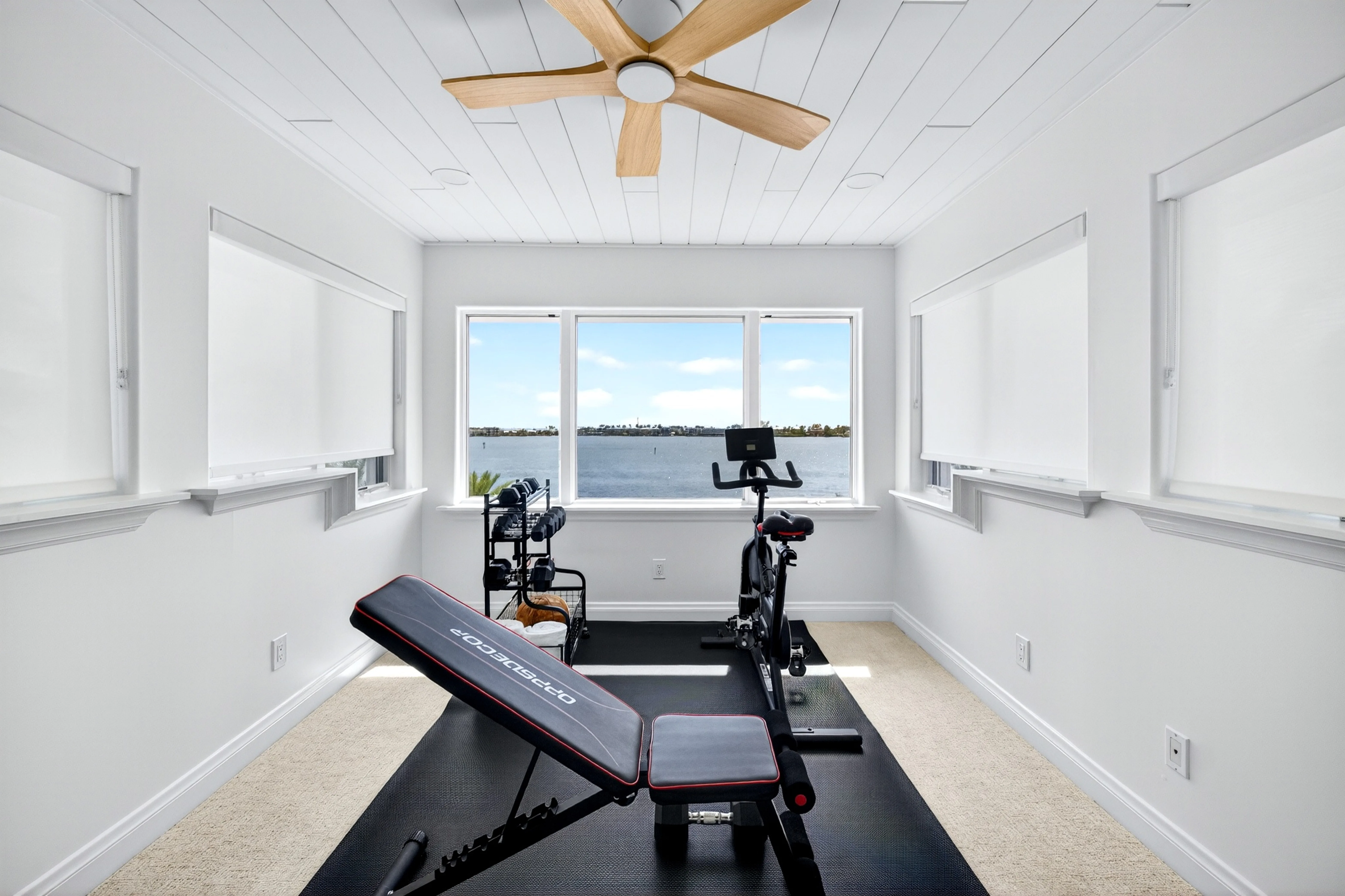 Waterfront fitness room with bay views