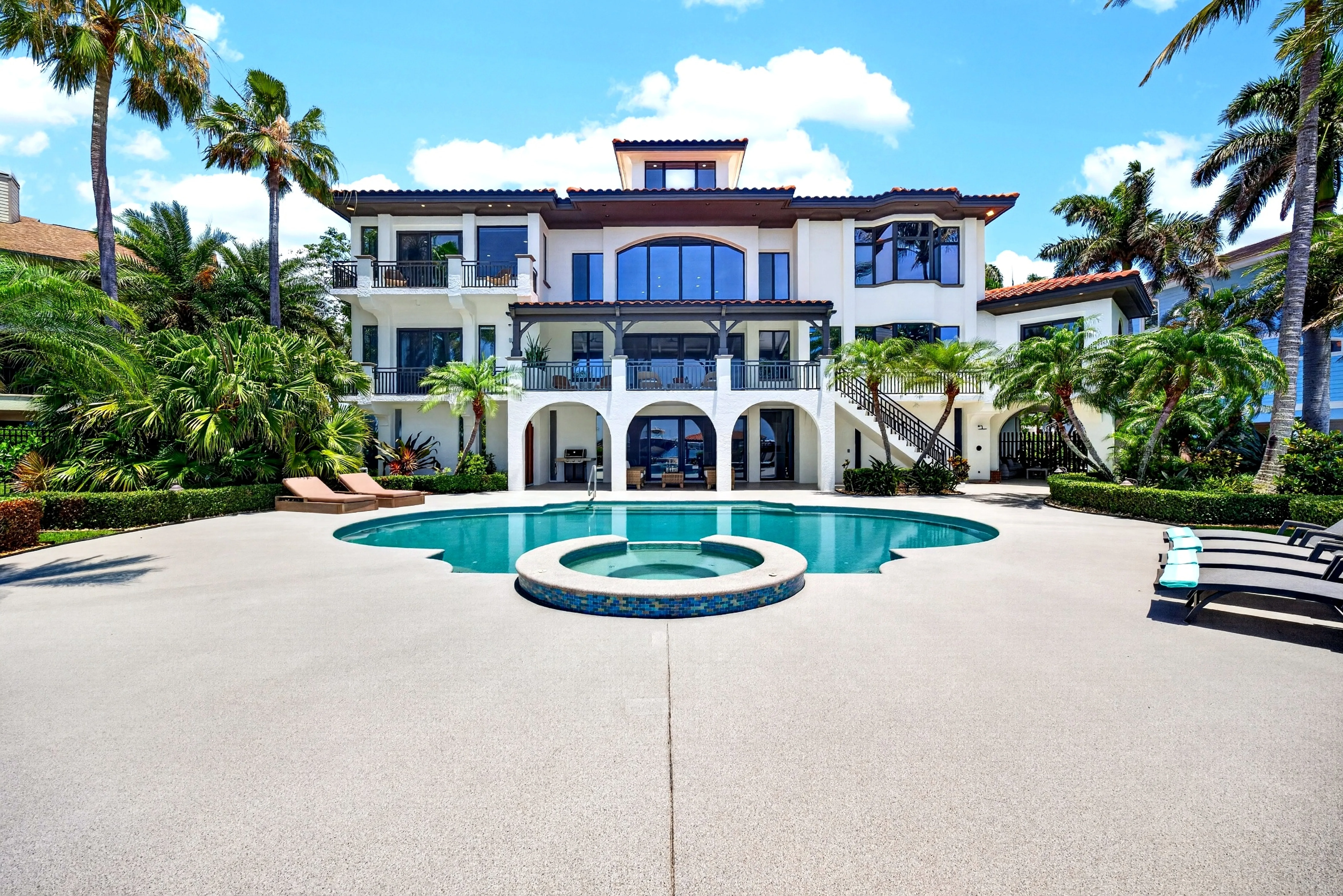 Rear elevation with pool and spa in foreground